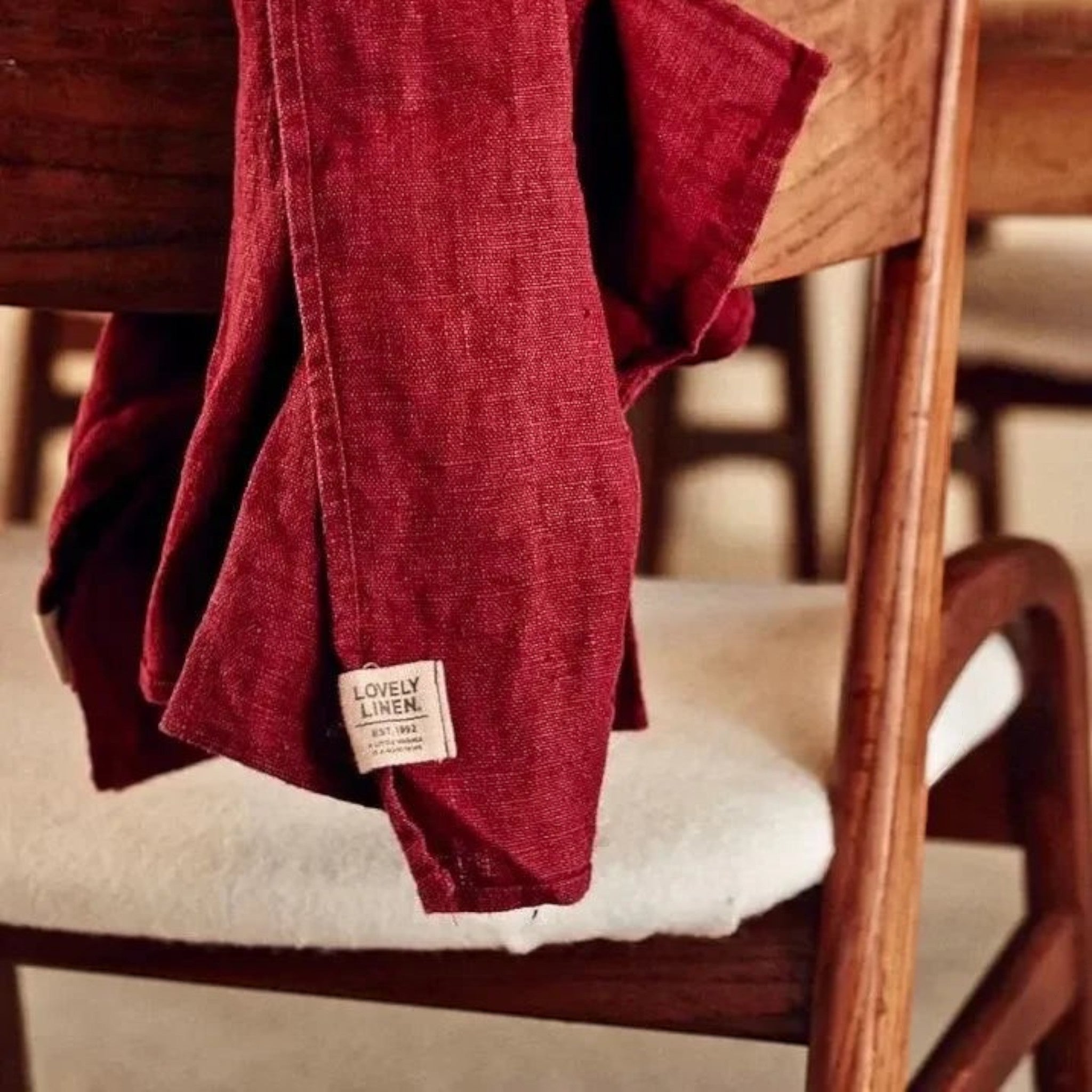 keep-collections red linen kitchen hand towel with rustic texture draped over a wooden chair