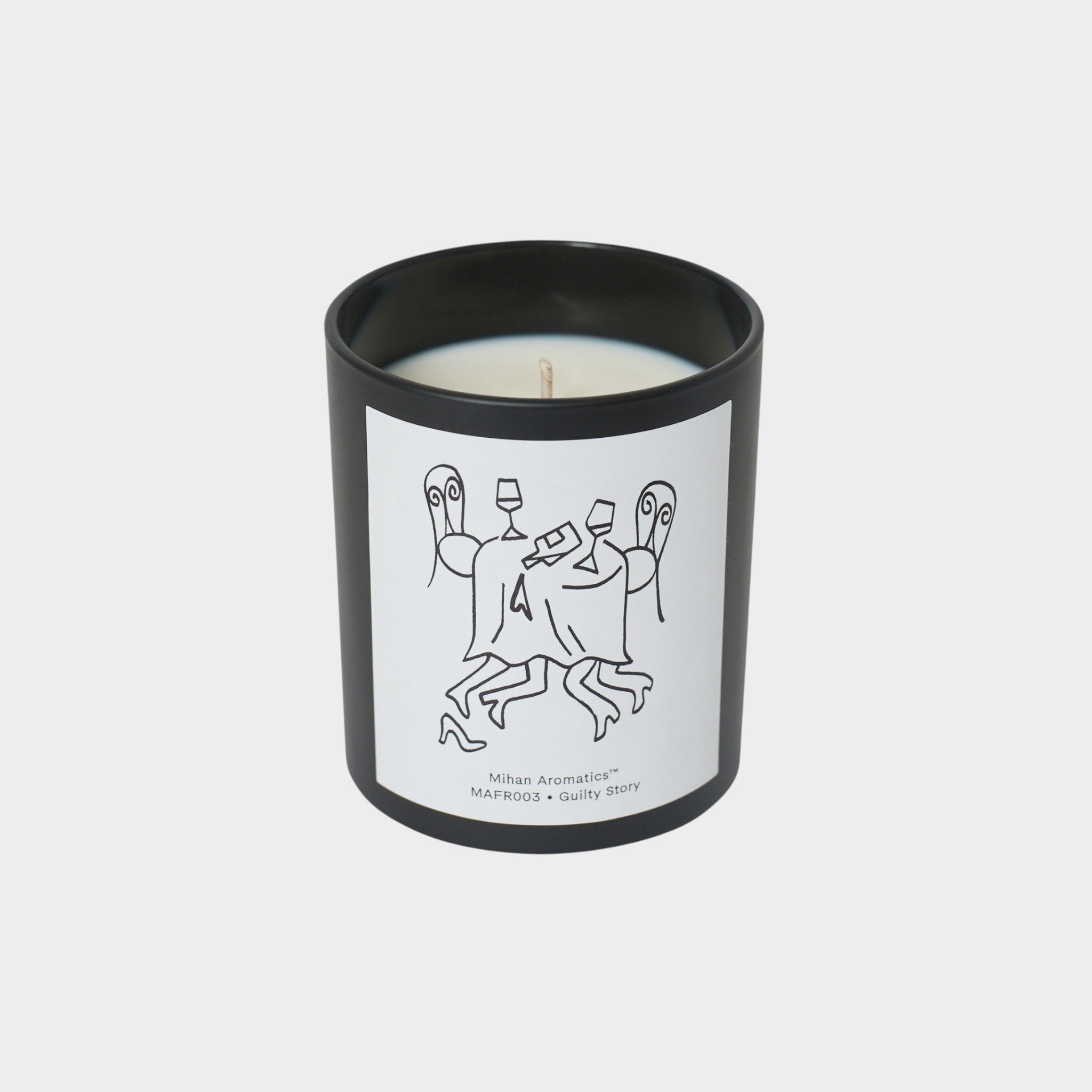 keep-collections Mihan Aromatics Guilty Story scented candle in a matte black glass vessel with a whimsical label