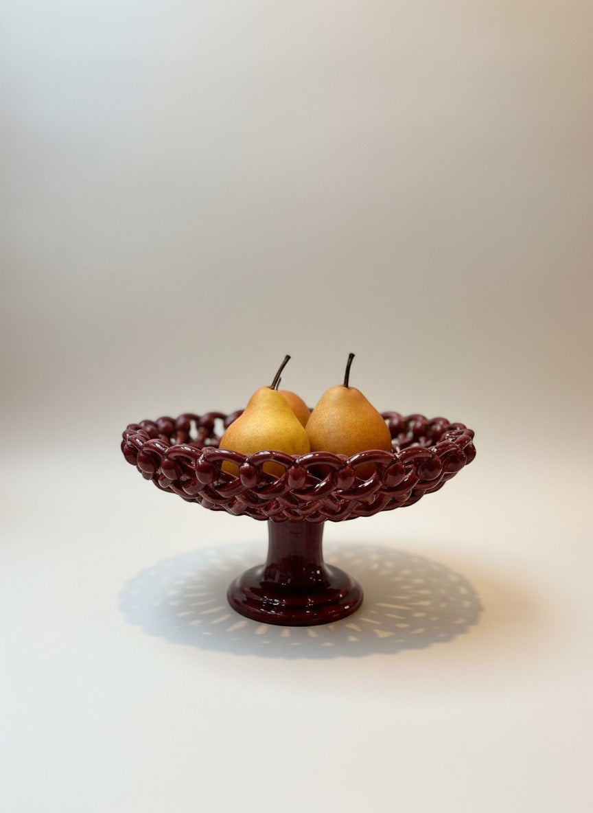 Keep Collections deep red ceramic pedestal fruit bowl with woven detailing, holding three pears.