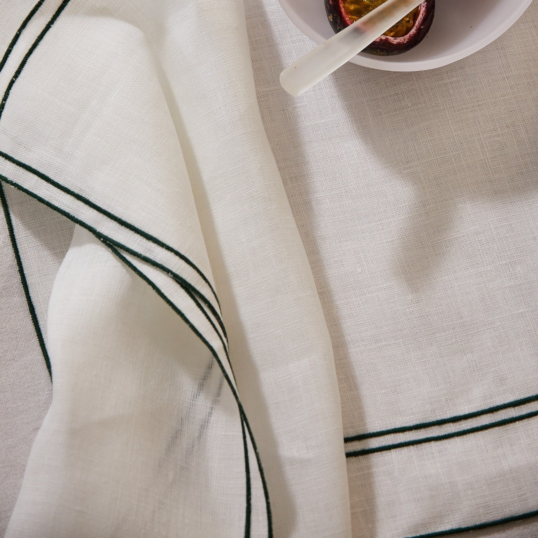Keep Collections white European flax linen placemat with deep green Art Deco embroidery detail. Set of four.